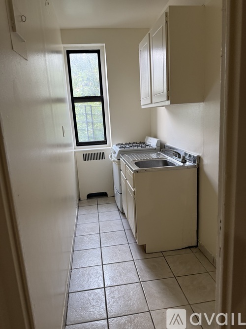 A small kitchen with a window and a sink.