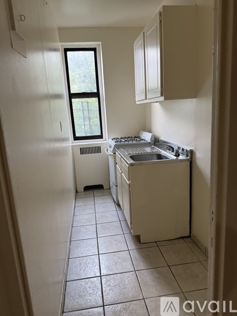 A small kitchen with a window and a sink.