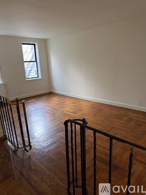 A room with wooden floors and a window.