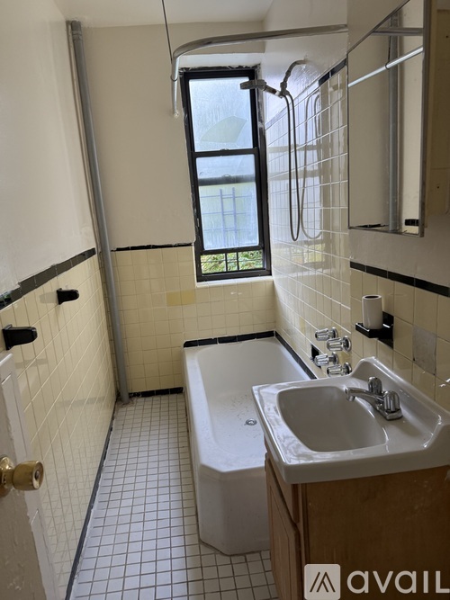 A bathroom with a white tub and sink.