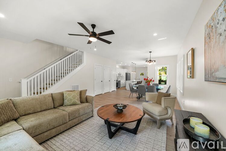 A living room with a brown couch and a coffee table.