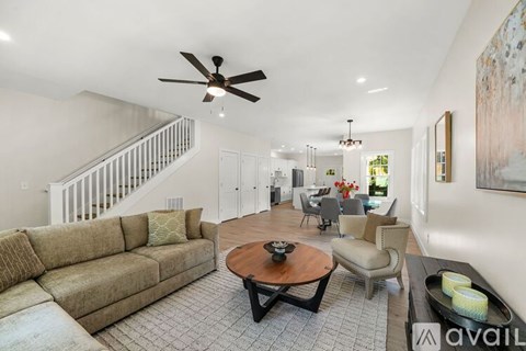 A living room with a brown couch and a coffee table.
