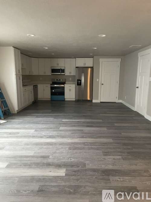 A kitchen with a stove top oven and a refrigerator.