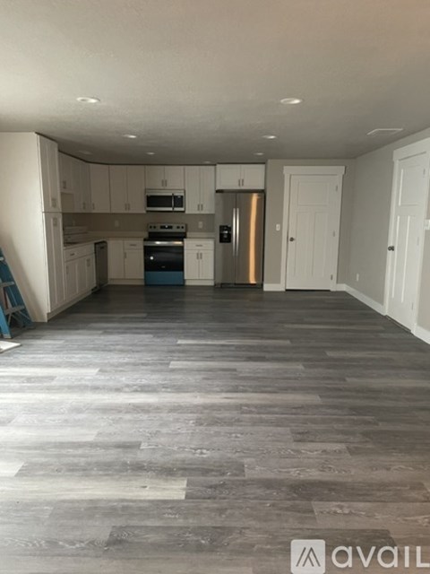A kitchen with a stove top oven and a refrigerator.