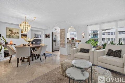 A living room with a dining table and chairs, a sofa, and a coffee table.
