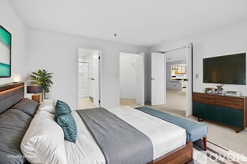 A bedroom with a large bed and a television.