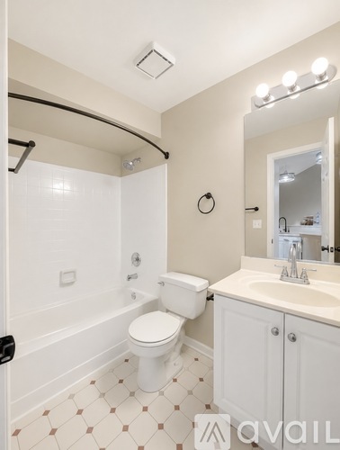 A bathroom with a toilet, sink, and shower.