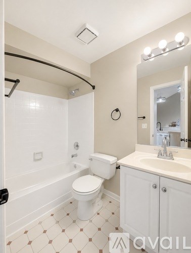 A bathroom with a toilet, sink, and shower.