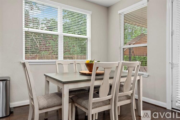 A dining room with a table and chairs.