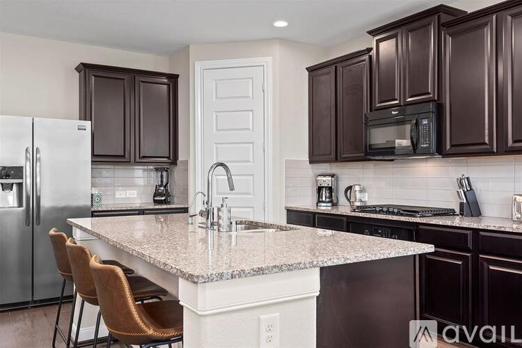 A kitchen with brown cabinets and a white island.