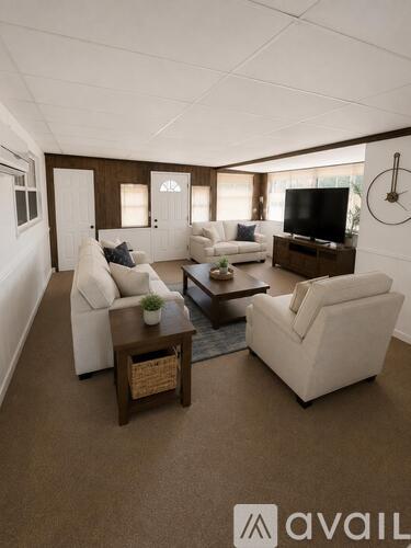 A living room with white furniture and a flat screen TV.