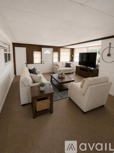 A living room with white furniture and a flat screen TV.