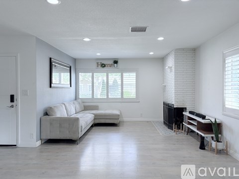 A living room with a grey sofa and a television.