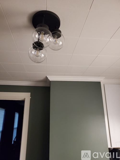 A white ceiling with four hanging light bulbs.