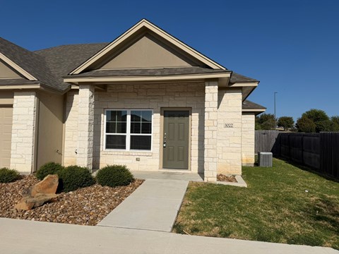 A house with a grey front door and a grey window.