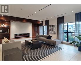 A modern living room with a fireplace and a striped rug.