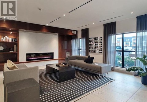 A modern living room with a fireplace and a striped rug.