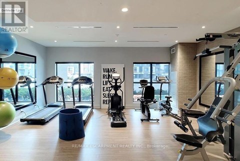 A gym with a variety of equipment including treadmills, stationary bikes, and weight machines.