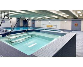 A swimming pool with a diving board and a sign that says "ROYAL LEPAGE SWIMMING POOL".