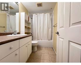 A bathroom with a sink, toilet, and bathtub.