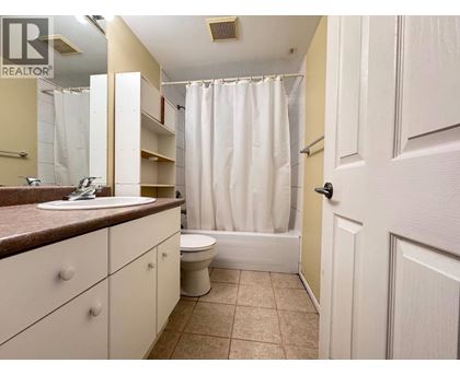 A bathroom with a sink, toilet, and bathtub.