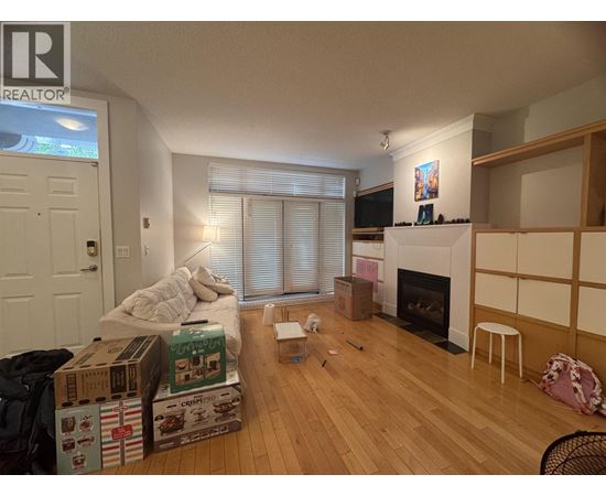 A room with a fireplace and a chair.
