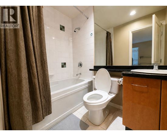 A bathroom with a toilet, sink, and bathtub.