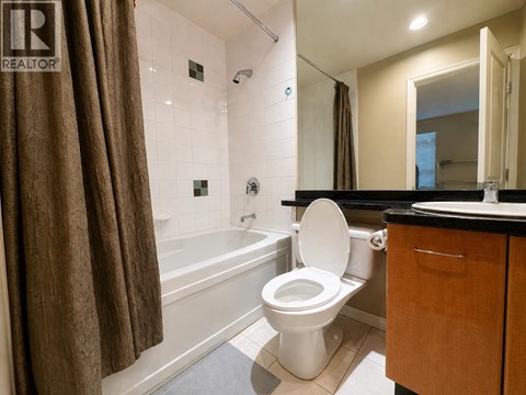 A bathroom with a toilet, sink, and bathtub.
