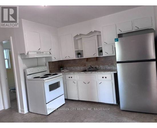 A kitchen with white appliances and cabinets.
