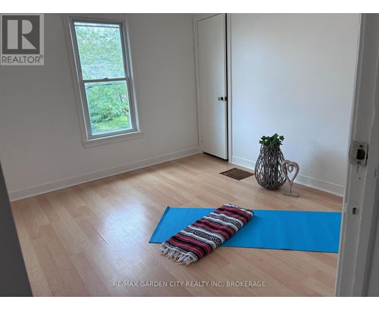 A room with a blue yoga mat on the floor.