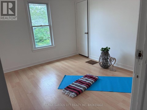 A room with a blue yoga mat on the floor.