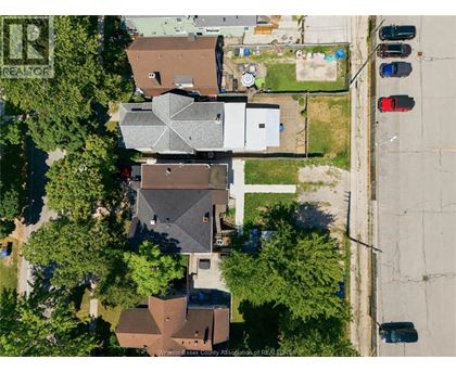 A bird's eye view of a neighborhood with houses and cars.