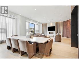 A modern dining room with a long table and chairs.