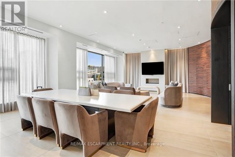 A modern dining room with a long table and chairs.