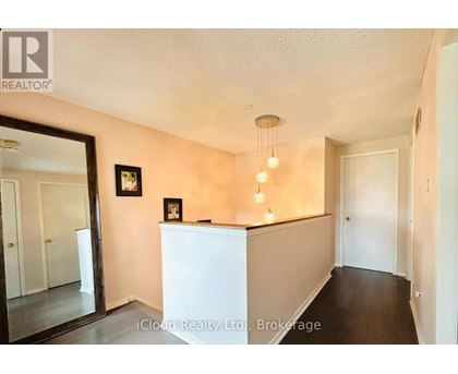 A room with a white counter and a framed picture on the wall.