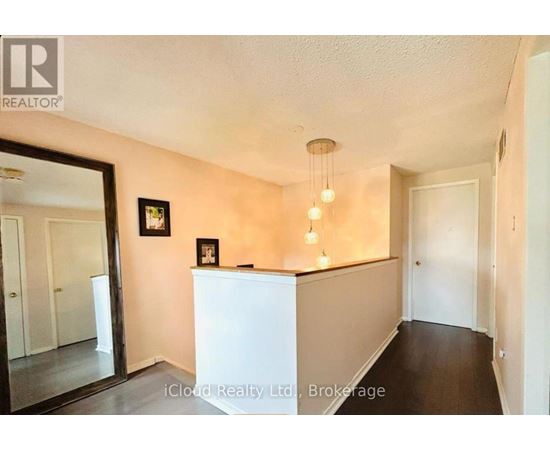 A room with a white counter and a framed picture on the wall.