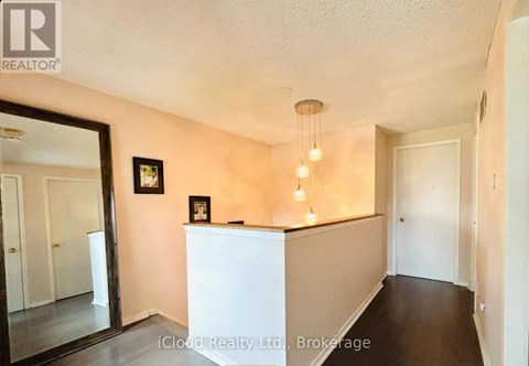 A room with a white counter and a framed picture on the wall.