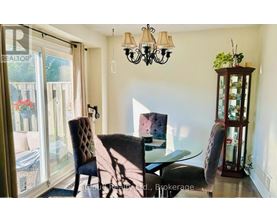 A dining room with a glass table and chairs.