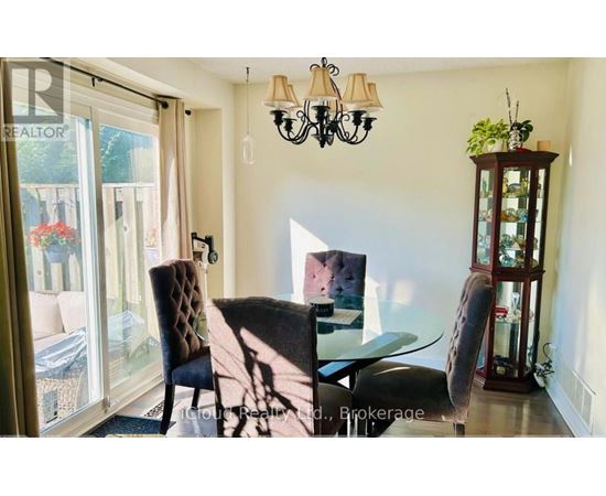 A dining room with a glass table and chairs.