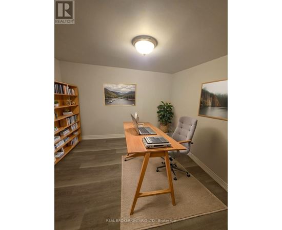 A room with a desk, chair, and bookshelf.