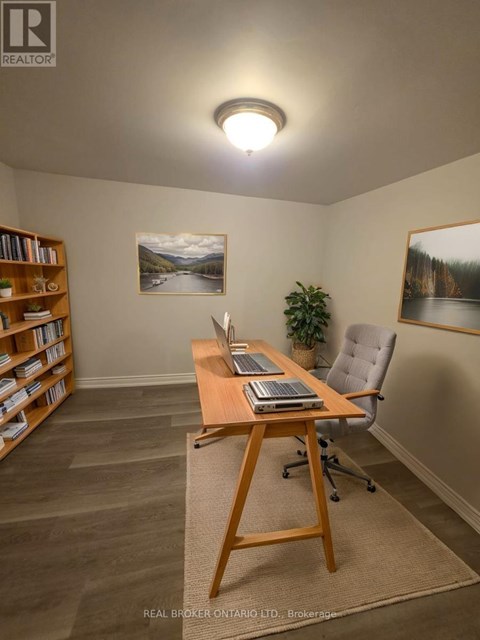 A room with a desk, chair, and bookshelf.