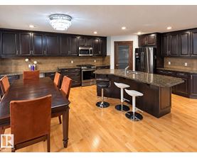 A kitchen with a table and chairs.
