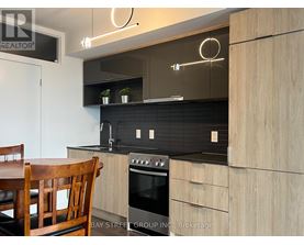 A modern kitchen with a wooden table and chairs.