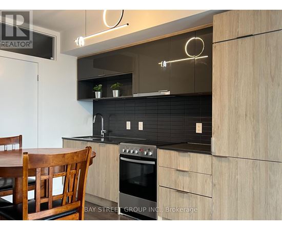 A modern kitchen with a wooden table and chairs.