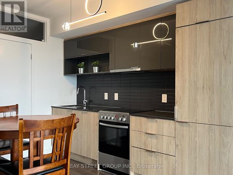 A modern kitchen with a wooden table and chairs.