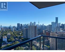 A cityscape viewed from a balcony with the Bay Street Group logo.