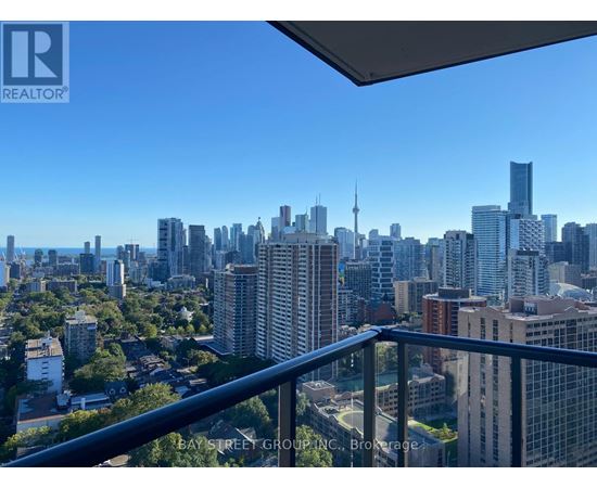 A cityscape viewed from a balcony with the Bay Street Group logo.