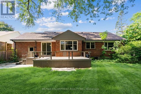 A house with a deck in the front yard.