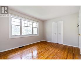 A room with a wooden floor and a window.