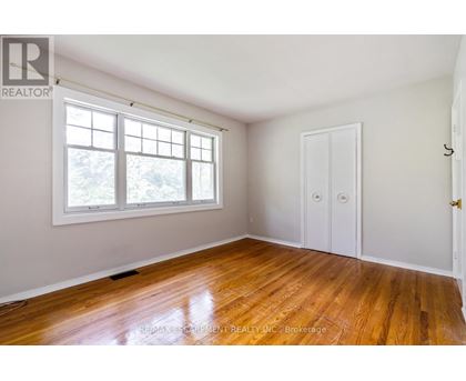 A room with a wooden floor and a window.